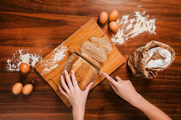 istock Close picture of hands cutting fresh bread 531786326