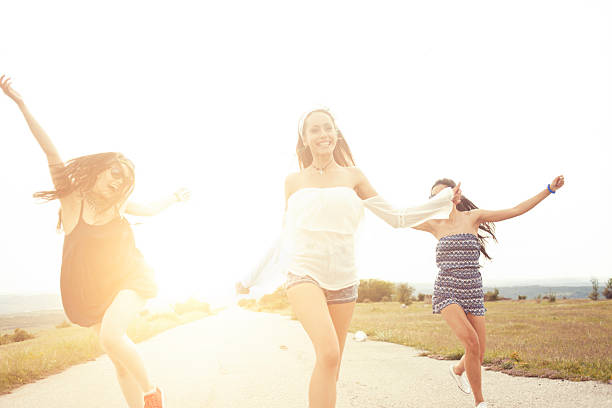 istock Happy hipster women dancing on the road 531788286