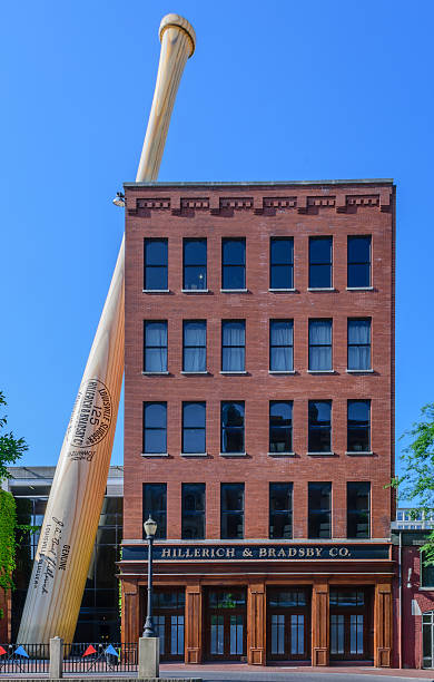 Louisville Slugger Museum & Factory Louisville, Kentucky, USA - May 15, 2016: A 6 story tall bat leans against the Louisville Slugger Museum & Factory in downtown Louisville Kentucky. The bat is billed as the largest in the world but is actually made of metal and is hollow. louisville kentucky stock pictures, royalty-free photos & images