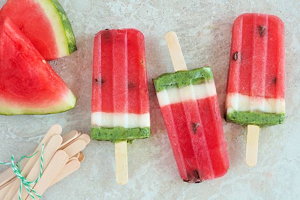 istock Watermelon popsicles with fresh melon slices on white marble 531790848