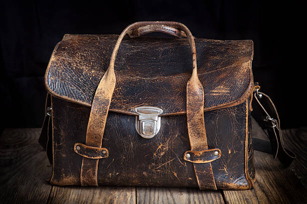 istock Old leather bag on wooden background 531792864