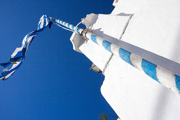 Traditional Greek church in Mykonos Town, with a Greek flag flying over it