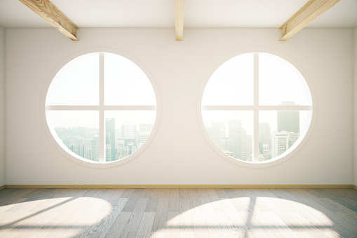 Sunlit interior design with wooden floor and circular windows revealing city view. 3D Rendering