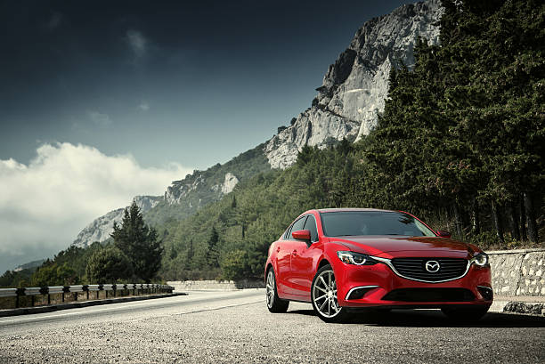 Car Mazda standing on the road near mountains at daytime stock photo