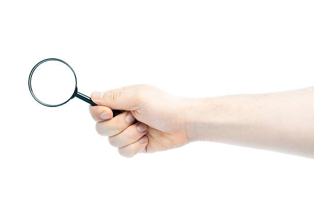 istock Caucasian male hand holding magnifying glass 531796230