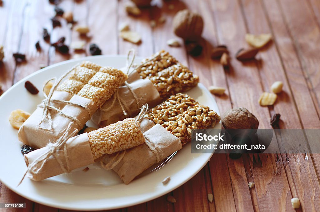 Granola bars made of sesame seeds, peanuts, cashew nuts. Vegetarian sweets. Granola bars made of sesame seeds, peanuts, cashew nuts, sunflowers seeds, oil and honey. Almond Stock Photo