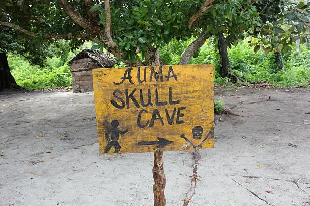 Sign with directions to one of the two skull caves on Kitava Island used by cannibals.