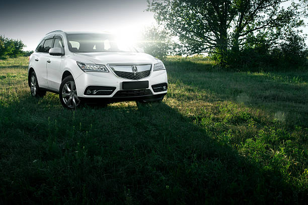 Modern car Acura MDX on road at sunset stock photo