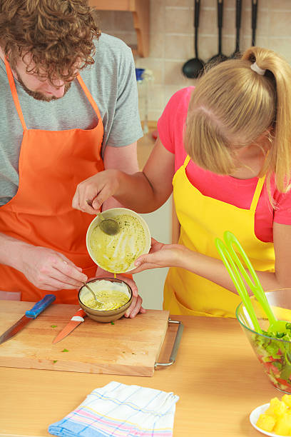 istock Couple preparing fresh salad dressing 531798080