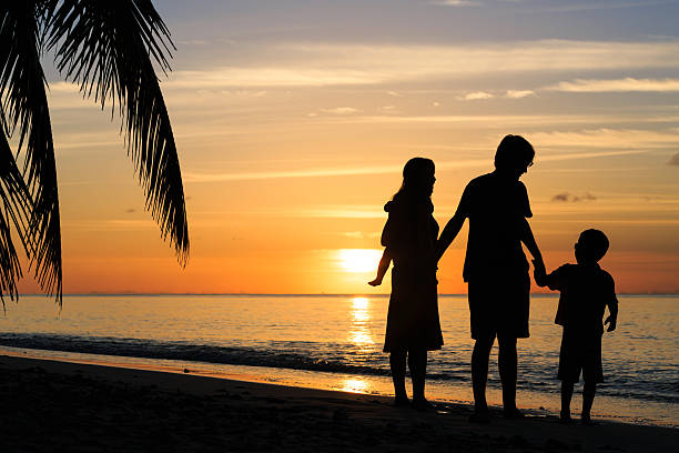 istock happy family with two kids on sunset beach 531799236