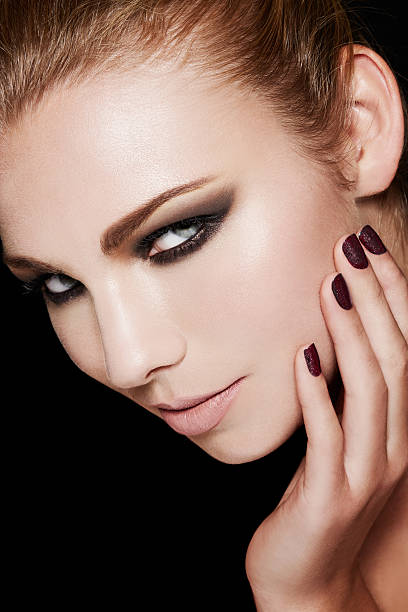 istock Beautiful smokey eyes makeup with black manicured nails. 531801310