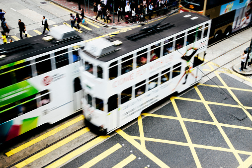 Trams pass on Des Voeux Road West, motion blur, Hong Kong. 