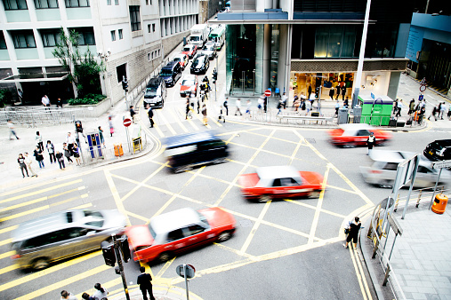 A junction and pedestrian crossing on Des Voeux Road West, Hong Kong. 