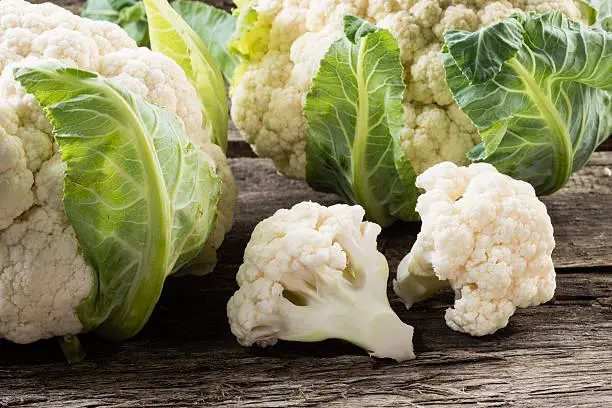 Photo of Organic cauliflower on wooden background