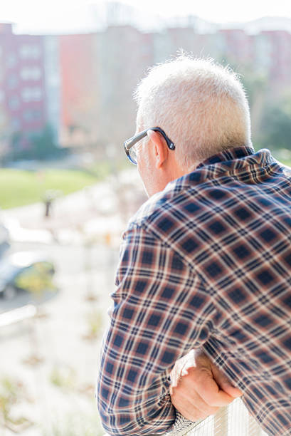istock adult man looking out the balcony 531824363