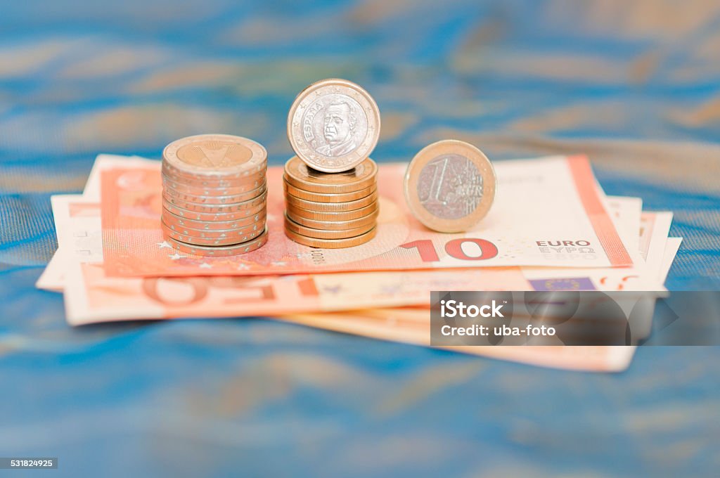 One Spanish euro One Spanish euro banknotes in front of blue background. 2015 Stock Photo