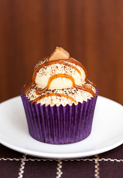 Cupcake  topped with cappuccino flavoured frosting and decorated with caramel