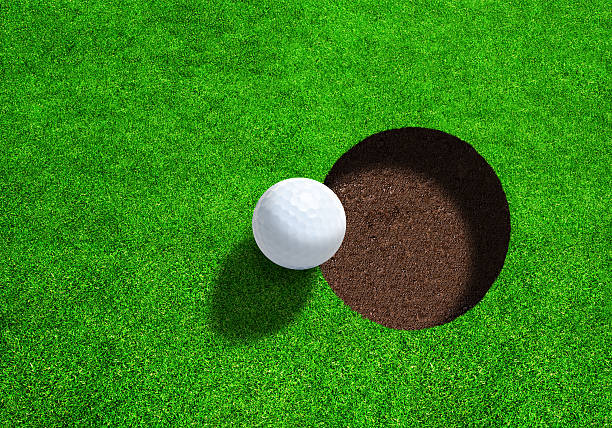 Golf Ball Close to Hole With Copy Space. Top View.