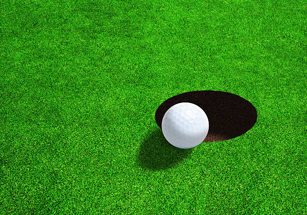 istock Side View of Golf Ball Close to Hole 531842126