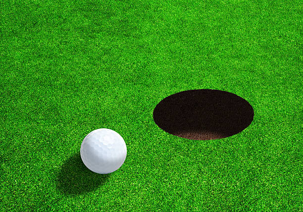 istock Side View of Golf Ball Close to Hole 531842164