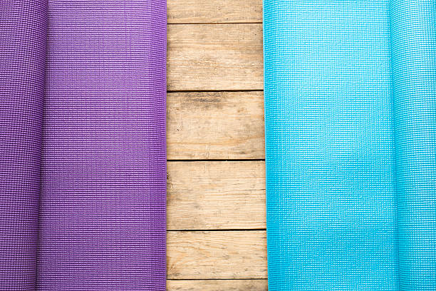 istock purple and blue yoga mat on table background 531842584