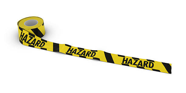 istock Yellow and Black Striped Hazard Tape Roll unrolled across white 531843040