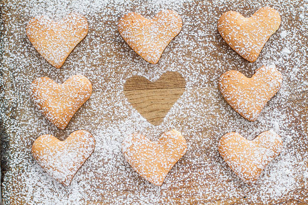istock Heart shaped cookies poweder with sugar, one silhouette 531843555