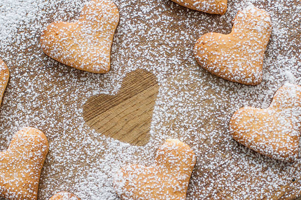 istock Heart shaped cookies poweder with sugar, one silhouette 531843565