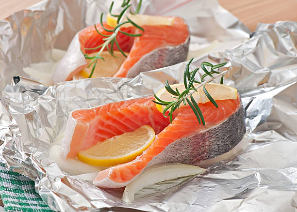 istock Prepared to bake in foil trout with onion and lemon 531843771