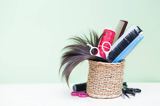Barber set with combs and scissors on the color pink, yellow, blue paper background. Top view. Copy space. Still life. Mock-up. Flat lay