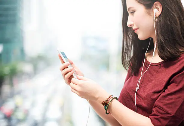 Photo of Woman Listening Music Media Entertainment Walking Concept