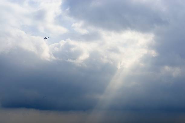 istock Airplane flying and Crepuscular rays 531847330