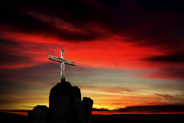istock Christian cross over dark red sunset background 531850968