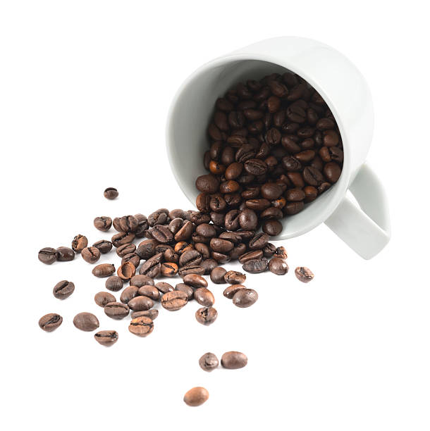 istock Spilled coffee beans from the cup isolated 531854120