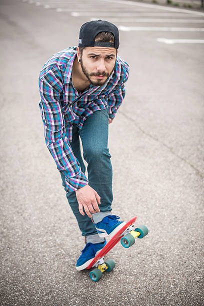 istock Stylish young guy on a red skateboard 531854122