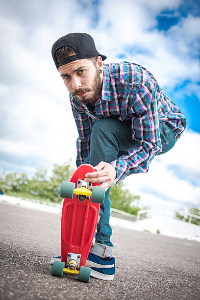 istock Stylish young guy on a red skateboard 531855982