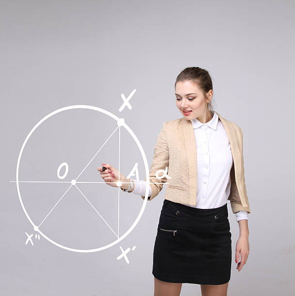 istock Woman with pen draws geometric shapes on grey background 531856738