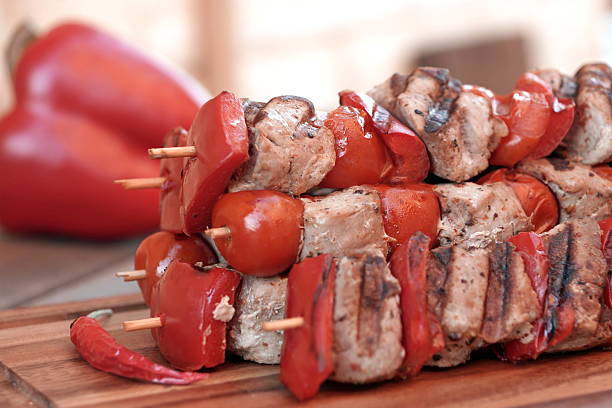 istock Stacked Skewered BBQ Shish Kebabs On The Wood Cutting Board 531857360