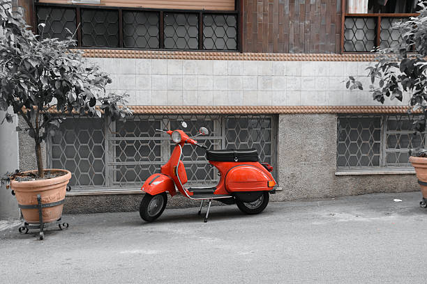 Red scooter and Roman wall, Rome Italy
