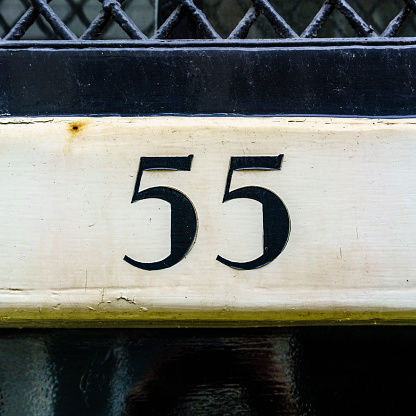 House number fifty five, made out of self adhesive numerals