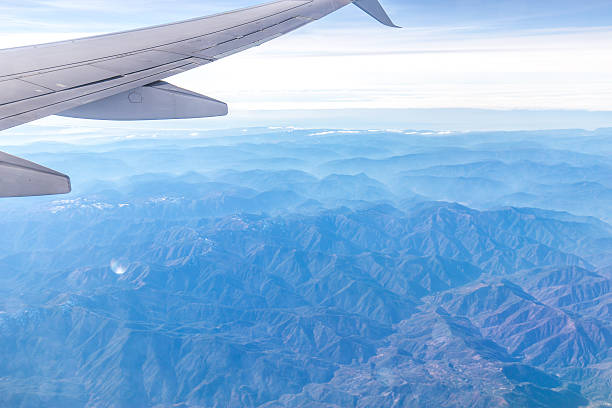 istock landscape of mountains through window of airplane 531858366