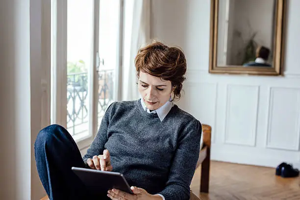french businesswoman using a tablet