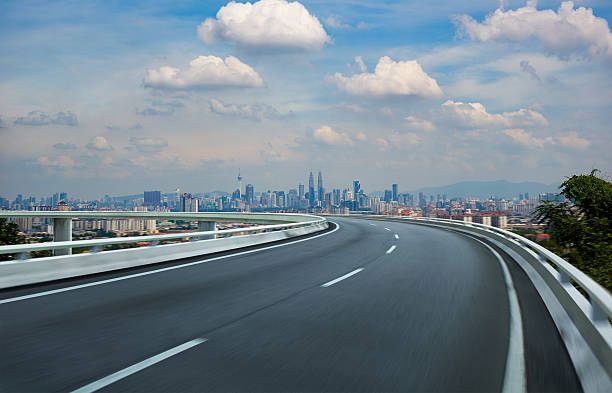 istock Highway overpass motion blur with city background . 531860514