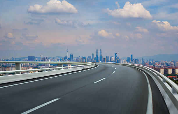 istock Highway overpass motion blur with city background . 531860590