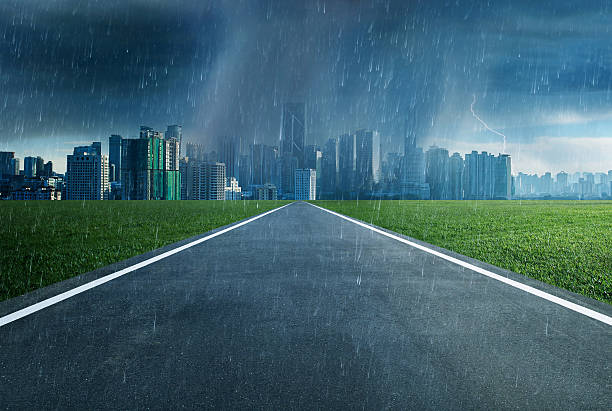 istock Empty asphalt road towards a city in storm 531861562