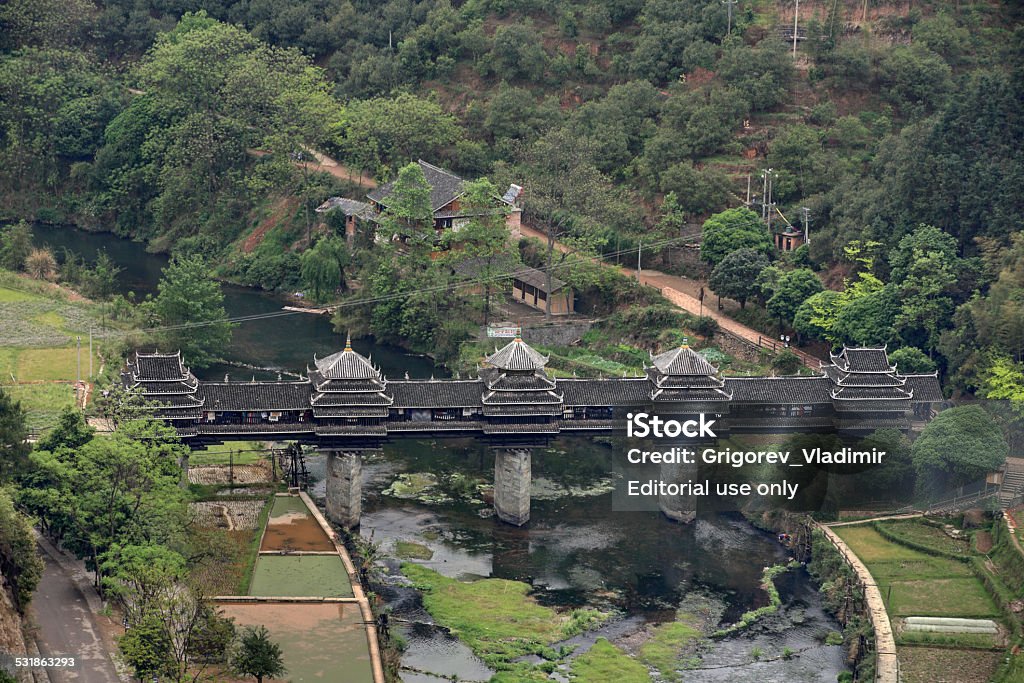 Wooden bridge village Chengyang, tourist attractions in the vicinity Sanjiang. Sanjiang, Guangxi Province, China - April 6, 2010:  wind and rain Bridge, Guangxi Autonomous Region, the old wooden bridge, Attractions Village Chengyang, situated near the city of Sanjiang. 2015 Stock Photo