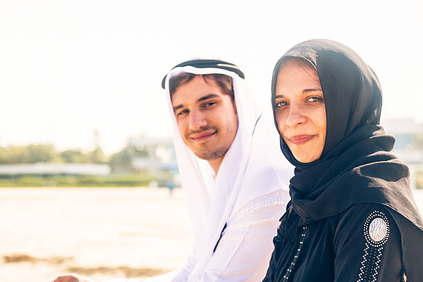 istock arabian couple sitting on the beach 531864279