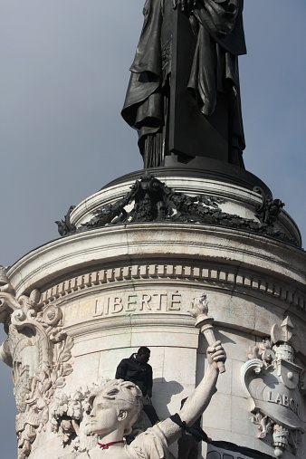 Paris, France - January 11, 2015: Black people on statue during manifestation on Republic Square in Paris against terrorism and in memory of the attack against satirical newspaper Charlie Hebdo.