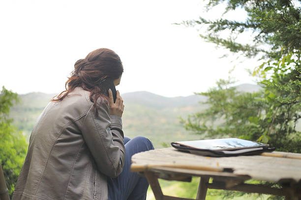 istock Young woman with her mobile phone in nature 531865720