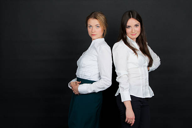 istock Two beautiful young brunette girl standing in white blouse 531866162